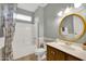 Well-maintained bathroom with a shower-tub combination and a vanity with decorative framed mirror at 15864 W Clearwater Way, Surprise, AZ 85374