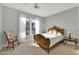 Cozy bedroom featuring a wooden bed frame, ceiling fan, and natural light from the window at 15864 W Clearwater Way, Surprise, AZ 85374