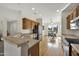 Open kitchen boasts stainless steel appliances, breakfast bar and an adjacent dining area with natural lighting at 15864 W Clearwater Way, Surprise, AZ 85374