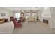 Spacious living room with a fireplace, ceiling fans, and carpet flooring provides an inviting atmosphere at 15864 W Clearwater Way, Surprise, AZ 85374