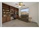 Functional home office complete with built-in shelving, comfortable seating, and natural light at 15864 W Clearwater Way, Surprise, AZ 85374