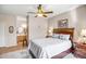 This bedroom features a wood frame bed and an open doorway to the ensuite bathroom at 16875 W Manchester Dr, Surprise, AZ 85374