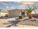 Charming single-story home featuring a well-manicured front yard and neutral color palette at 16875 W Manchester Dr, Surprise, AZ 85374