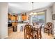Eat-in kitchen featuring modern appliances, hardwood cabinetry, and large sliding glass doors at 16875 W Manchester Dr, Surprise, AZ 85374