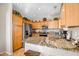 Contemporary kitchen showcasing stainless steel appliances, granite countertops, and functional design at 16875 W Manchester Dr, Surprise, AZ 85374