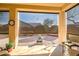 Relaxing covered patio with privacy screens and a peaceful view of the backyard at 16875 W Manchester Dr, Surprise, AZ 85374