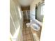 Tiled bathroom featuring a shower stall, toilet and sink with white cabinet at 1819 W Morten Ave, Phoenix, AZ 85021