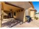 Cozy back patio with a BBQ, seating area and shade at 19863 N Emmerson Dr, Maricopa, AZ 85138