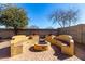 Outdoor oasis with a custom-built fire pit and seating, perfect for entertaining guests at 19863 N Emmerson Dr, Maricopa, AZ 85138