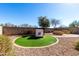 Beautiful backyard features turf and a cozy sitting area with built in benches, BBQ and covered grill at 19863 N Emmerson Dr, Maricopa, AZ 85138