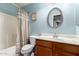Well-lit bathroom featuring a tub, toilet, vanity with a sink and an oval mirror at 19863 N Emmerson Dr, Maricopa, AZ 85138