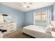 A bright bedroom offers a window and a white dresser with mirror at 19863 N Emmerson Dr, Maricopa, AZ 85138