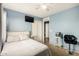 This bright bedroom features a ceiling fan, closet, and an ensuite bathroom at 19863 N Emmerson Dr, Maricopa, AZ 85138