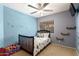 Charming bedroom featuring playful dinosaur bedding, a ceiling fan, and cozy decor at 19863 N Emmerson Dr, Maricopa, AZ 85138