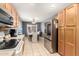 Eat in kitchen with stainless steel appliances and a dining area with natural light at 19863 N Emmerson Dr, Maricopa, AZ 85138