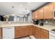 Bright kitchen features wooden cabinets, modern appliances, and access to the living area at 19863 N Emmerson Dr, Maricopa, AZ 85138