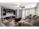Stylish living room featuring comfortable seating, a ceiling fan, and a modern entertainment setup at 19863 N Emmerson Dr, Maricopa, AZ 85138