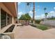 A home backyard featuring a seating area, mature trees, garden, and views of the surrounding property at 2107 E Inca St, Mesa, AZ 85213