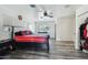 Comfortable main bedroom with ceiling fan, dark furniture, and wood-look vinyl flooring at 2107 E Inca St, Mesa, AZ 85213