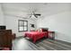 Cozy bedroom with ceiling fan, wood-look vinyl floors, and a red comforter set at 2107 E Inca St, Mesa, AZ 85213