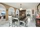 Dining room featuring decorative arches and a large table with a bench at 2107 E Inca St, Mesa, AZ 85213