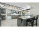 Spacious kitchen features gray cabinets, granite counters, island with bar seating and views to the yard at 2107 E Inca St, Mesa, AZ 85213