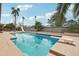 Sparkling pool with diving board and slide surrounded by palm trees in backyard at 2107 E Inca St, Mesa, AZ 85213