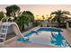 Backyard pool featuring a slide, palm trees, and privacy walls ideal for relaxation and summer fun at 2107 E Inca St, Mesa, AZ 85213