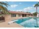 Back of home with pool featuring mature landscaping and a diving board at 2107 E Inca St, Mesa, AZ 85213
