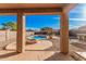 Covered patio view overlooking a pool, fire pit, and outdoor kitchen, perfect for entertaining or relaxation at 22157 W Moonlight Path, Buckeye, AZ 85326