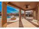 Spacious covered patio, perfect for outdoor entertaining, overlooking a pool and firepit in a well landscaped backyard at 22157 W Moonlight Path, Buckeye, AZ 85326