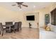 Dining room with hardwood floors, a wall-mounted television, and a cozy seating area at 22157 W Moonlight Path, Buckeye, AZ 85326