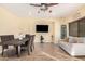 Dining room featuring a modern table and chairs, a ceiling fan, and a comfortable sofa at 22157 W Moonlight Path, Buckeye, AZ 85326