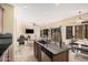 Gourmet kitchen with an island, stainless steel dishwasher, and an open flow to the living space at 22157 W Moonlight Path, Buckeye, AZ 85326