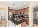 Updated kitchen with an island, granite counters, stainless steel appliances, and ample storage at 22157 W Moonlight Path, Buckeye, AZ 85326