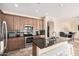 Open-concept kitchen features a breakfast bar, stainless appliances, and seamless flow to the dining area at 22157 W Moonlight Path, Buckeye, AZ 85326