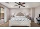 Serene main bedroom with ceiling fan, side tables, and a large window offering natural light at 22157 W Moonlight Path, Buckeye, AZ 85326