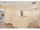 Bright upstairs hallway with neutral carpet, white walls, and access to bedrooms and living spaces at 22157 W Moonlight Path, Buckeye, AZ 85326