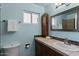 Bright bathroom featuring blue walls, a modern vanity, framed mirror and tiled accents at 2230 W Peralta Ave, Mesa, AZ 85202