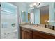 Updated bathroom featuring modern vanity, countertop, framed mirror, and a tiled shower at 2230 W Peralta Ave, Mesa, AZ 85202