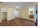 Bright bedroom featuring wood floors, a ceiling fan, and access to an ensuite bathroom for added convenience at 2230 W Peralta Ave, Mesa, AZ 85202