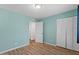 Bedroom featuring wood-look floors and a closet at 2230 W Peralta Ave, Mesa, AZ 85202