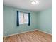 A cozy bedroom with natural light and wood-look floors at 2230 W Peralta Ave, Mesa, AZ 85202