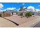 Charming single-story home features a well-maintained yard, white exterior, and solar panels at 2230 W Peralta Ave, Mesa, AZ 85202