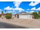 Charming single-story home features a well-maintained yard, white exterior, and a two-car garage at 2230 W Peralta Ave, Mesa, AZ 85202