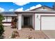 A well-maintained home exterior featuring solar panels, and a tidy entrance at 2230 W Peralta Ave, Mesa, AZ 85202