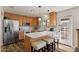 Bright kitchen boasts stainless steel appliances, a stylish breakfast bar with seating, and convenient access to the outdoors at 2230 W Peralta Ave, Mesa, AZ 85202