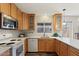 The kitchen boasts wooden cabinets, white countertops, tile backsplash, and modern appliances for a functional cooking space at 2230 W Peralta Ave, Mesa, AZ 85202