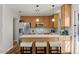 Well-lit kitchen featuring stainless steel appliances, a breakfast bar with seating, and ample cabinet space for storage at 2230 W Peralta Ave, Mesa, AZ 85202