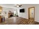 Living room showcasing a fireplace, an adjacent kitchen, and natural light at 2230 W Peralta Ave, Mesa, AZ 85202